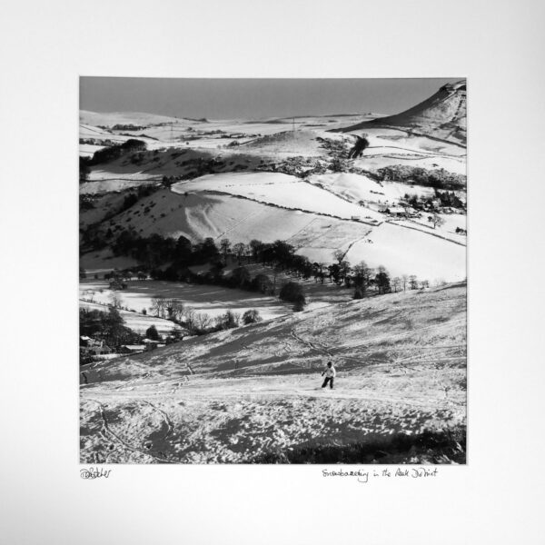 A snowboarder above village of Combs near Chapel-en-le-Frith and Whaley Bridge, near Buxton, Peak District